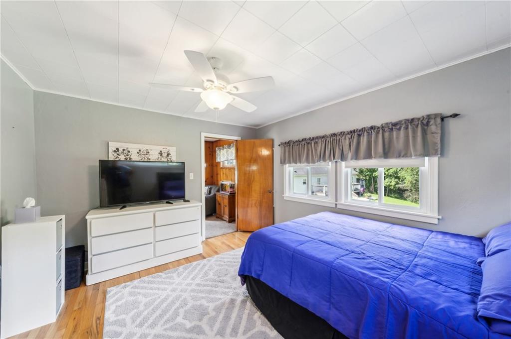 401 Finley Road Pittsburgh, PA 15239 - Photo 20 of 35 a spacious bedroom with a bed and a flat screen tv