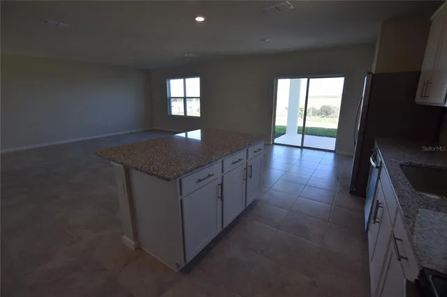 a kitchen with cabinets and window