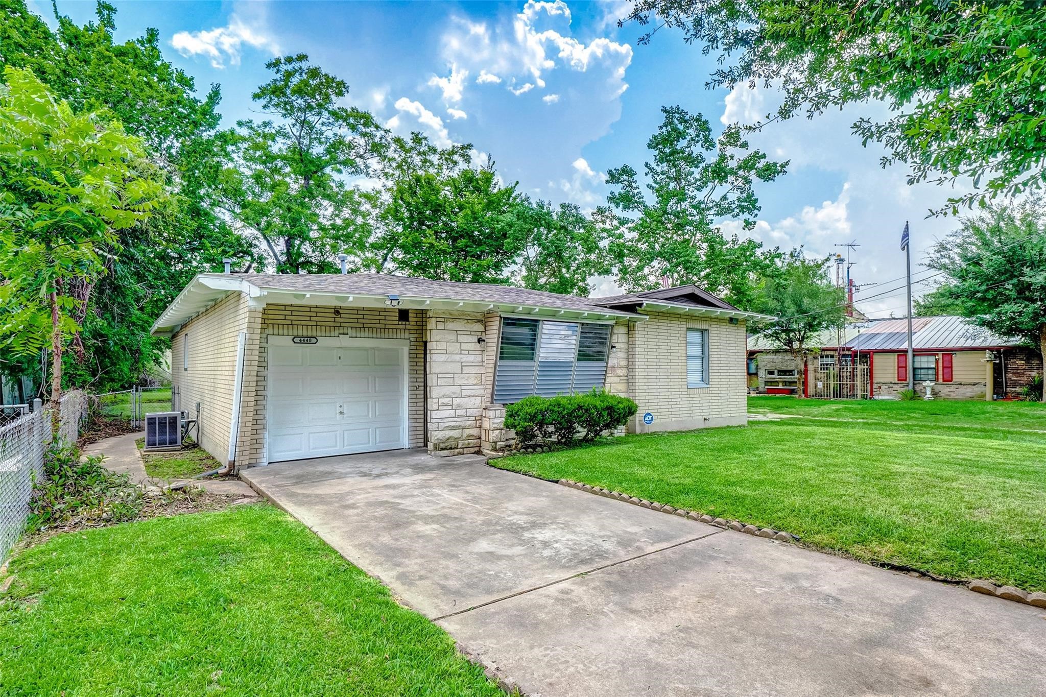 a front view of a house with a garden and yard