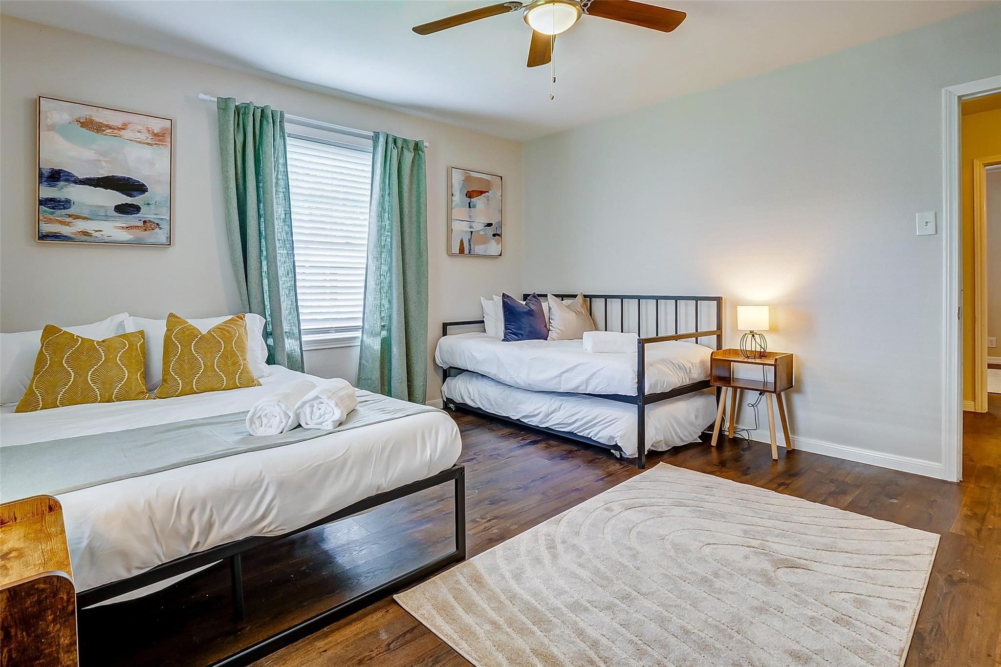 4440 Castor Street Houston, TX 77022 - Photo 12 of 30 a bedroom with a bed and a chandelier