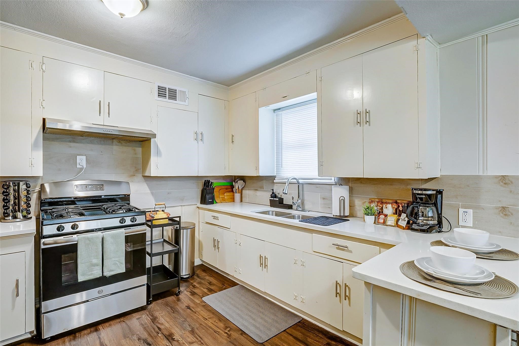 4440 Castor Street Houston, TX 77022 - Photo 19 of 30 a kitchen with stainless steel appliances a stove a sink and cabinets