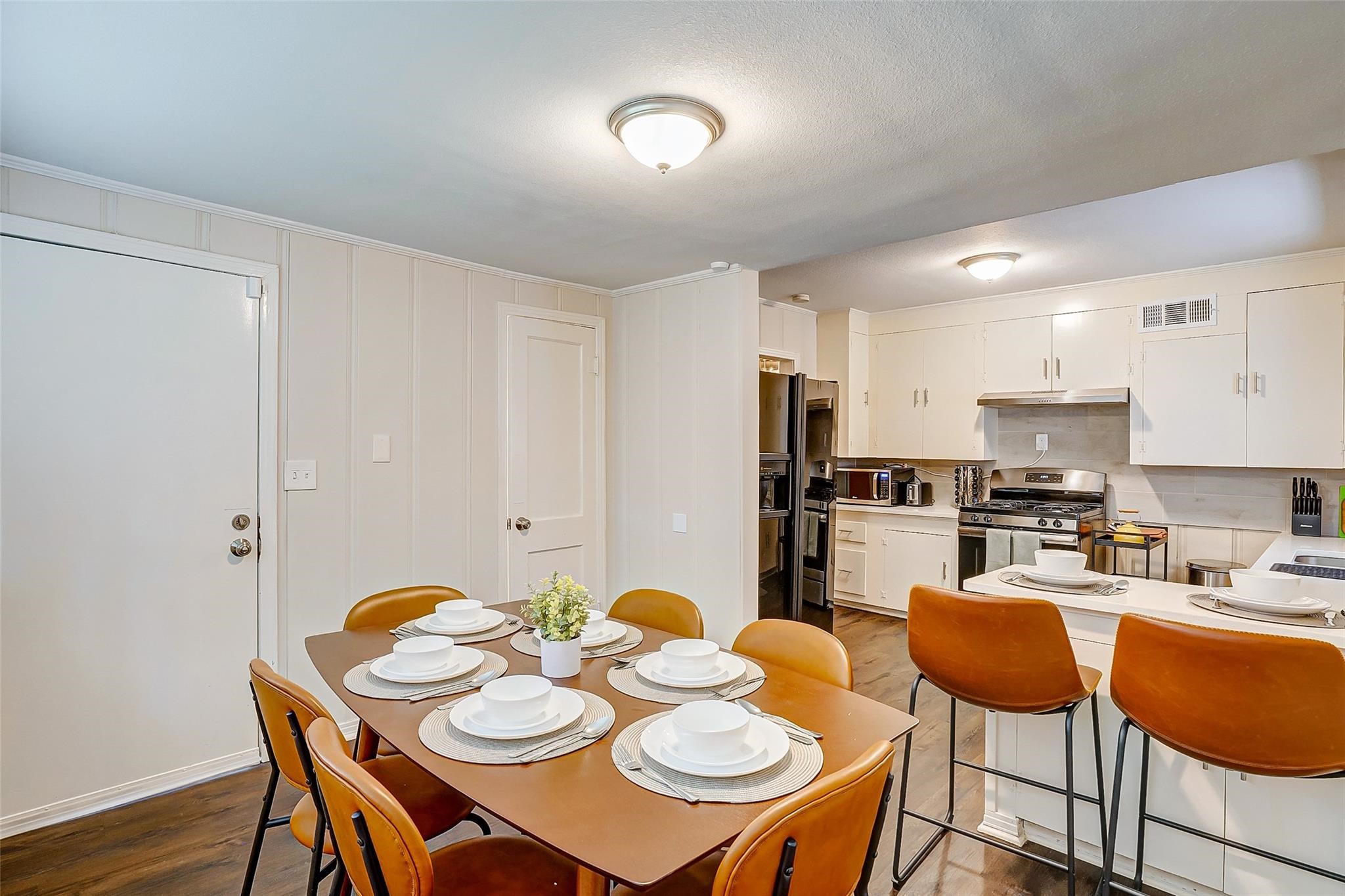 4440 Castor Street Houston, TX 77022 - Photo 20 of 30 a kitchen with stainless steel appliances kitchen island granite countertop a dining table and chairs