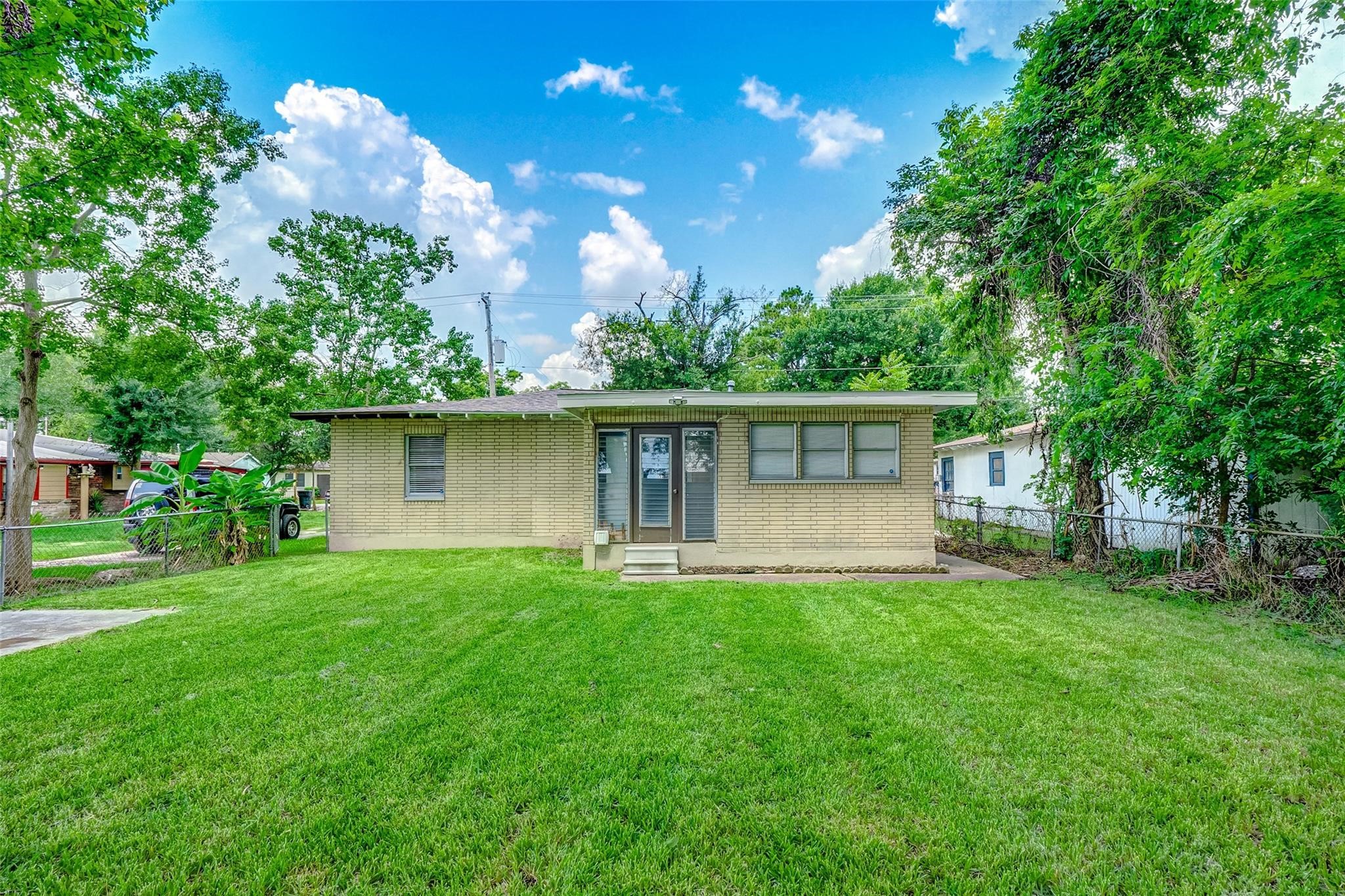 4440 Castor Street Houston, TX 77022 - Photo 2 of 30 a front view of a house with a yard and trees