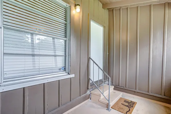 a view of a balcony with chair and door