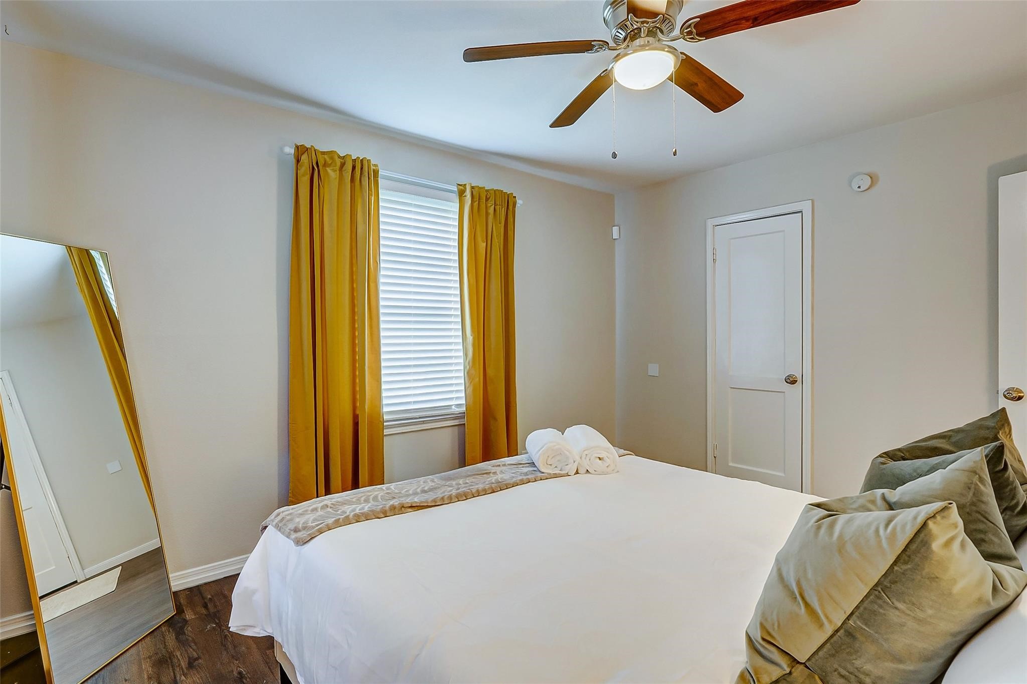 4440 Castor Street Houston, TX 77022 - Photo 6 of 30 a bedroom with a bed and a chandelier