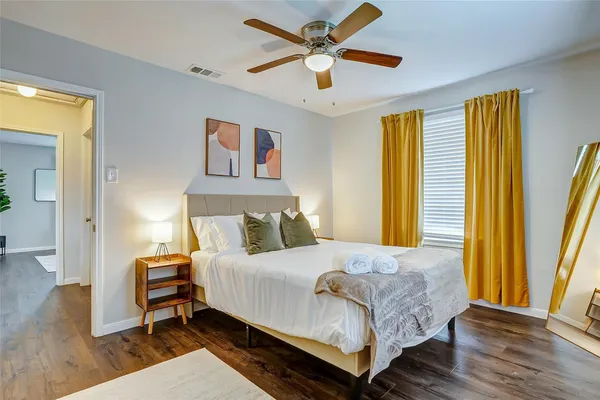a bedroom with a bed and wooden floor