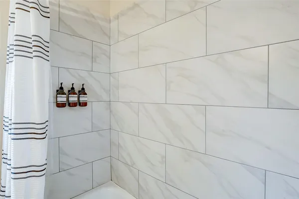a bathroom with a close up of a shower and a sink