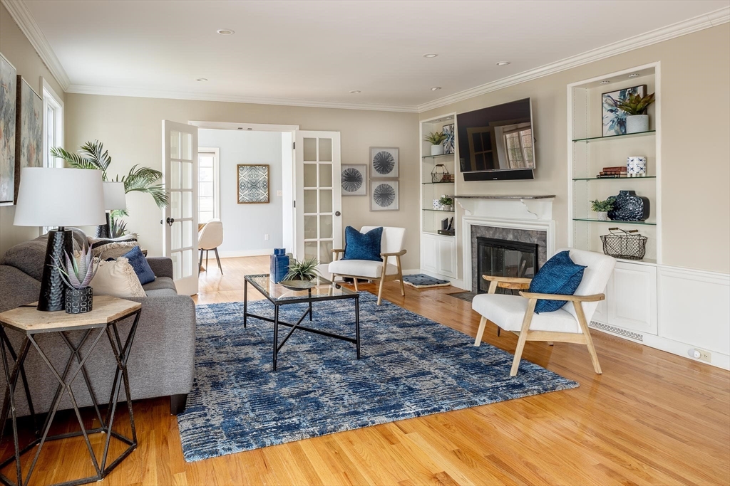 65 Rokeby Road Newton, MA 02468 - Photo 2 of 13 a living room with furniture a fireplace and a flat screen tv