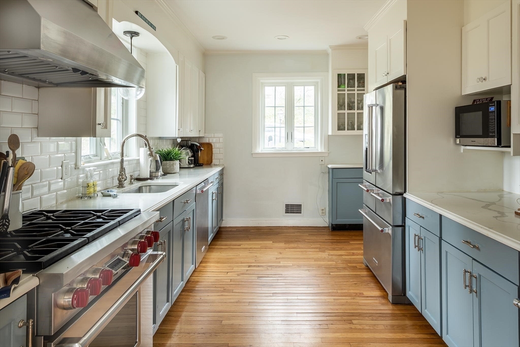 65 Rokeby Road Newton, MA 02468 - Photo 5 of 13 a kitchen with stainless steel appliances a sink stove refrigerator and window