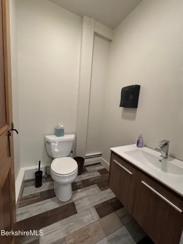 a bathroom with a toilet a sink and mirror