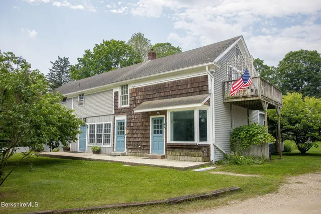 a view of a house with a yard and plants