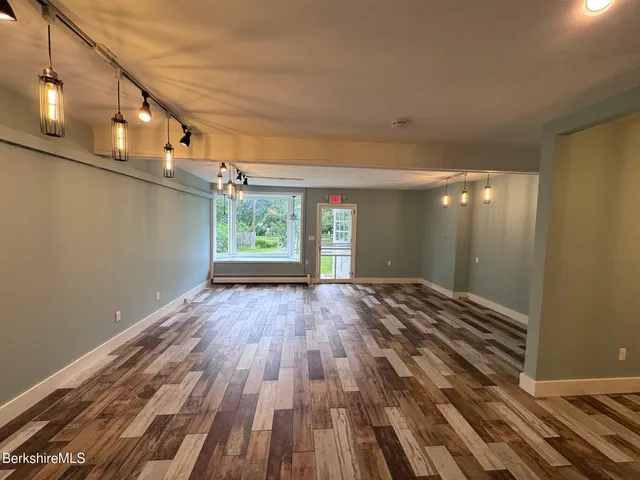 a view of a room with wooden floor and window
