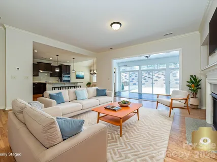 a living room with furniture dining table and a large window