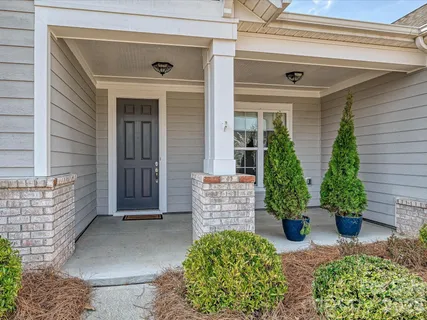 front view of a house with potted plants