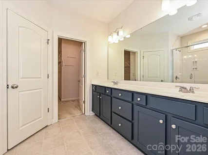 a bathroom with double vanity sink and a mirror