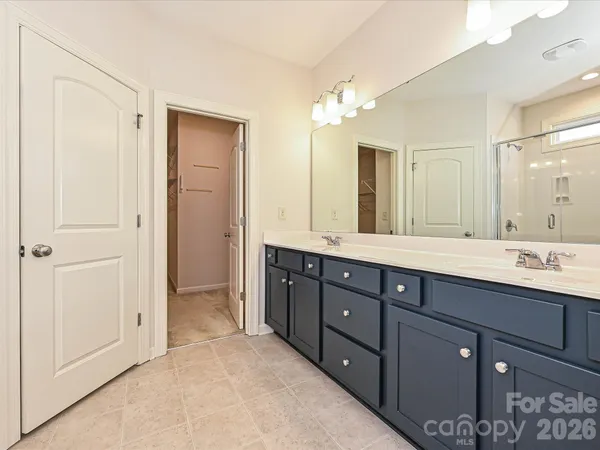 a bathroom with double vanity sink and a mirror