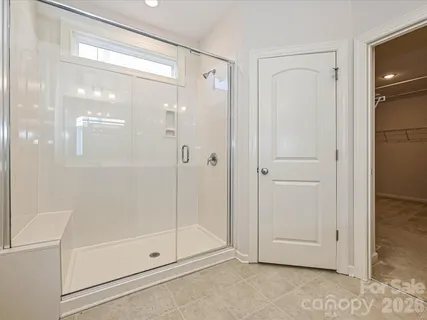 a bathroom with a glass shower door