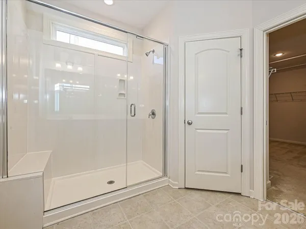 a bathroom with a glass shower door