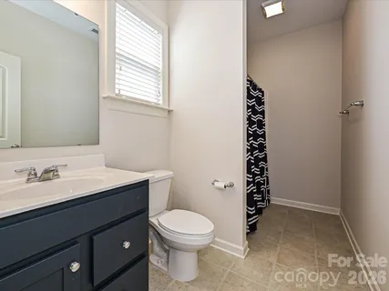 a bathroom with a toilet a sink and a window