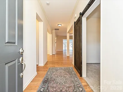 a view of hallway with wooden floor