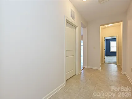 a view of a hallway with wooden shelves
