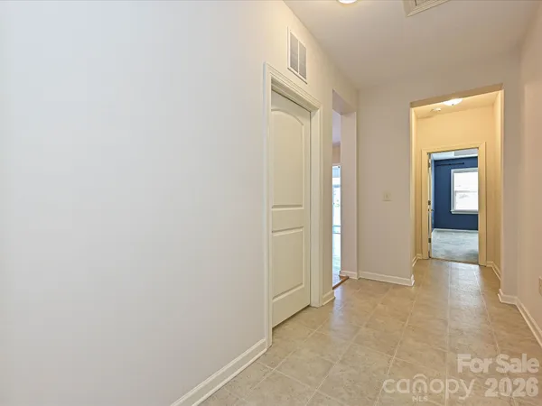a view of a hallway with wooden shelves