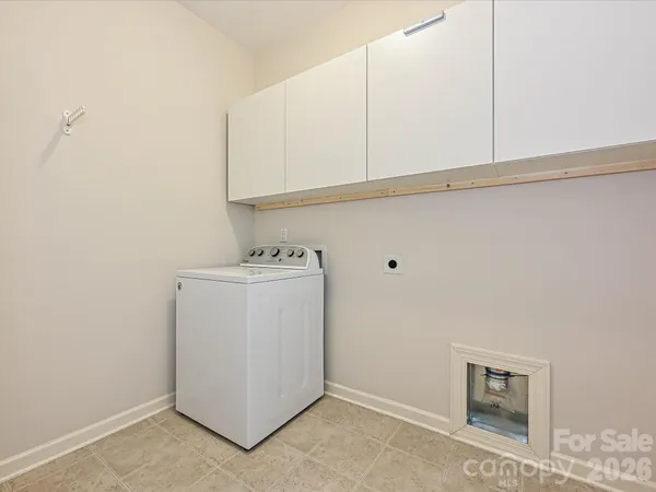 a utility room with cabinets washer and dryer