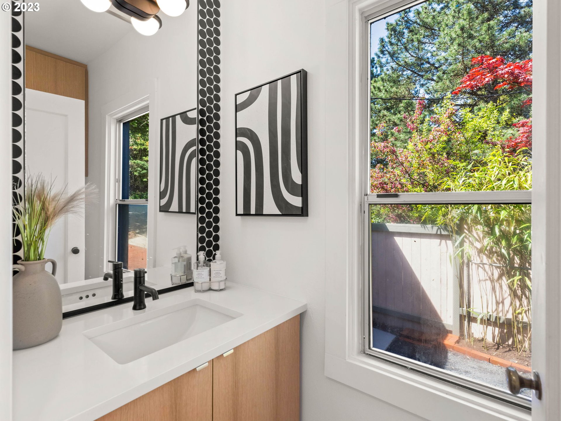 3590 Southwest Patton Road Portland, OR 97221 - Photo 18 of 32 a bathroom with a sink a mirror and next to a window