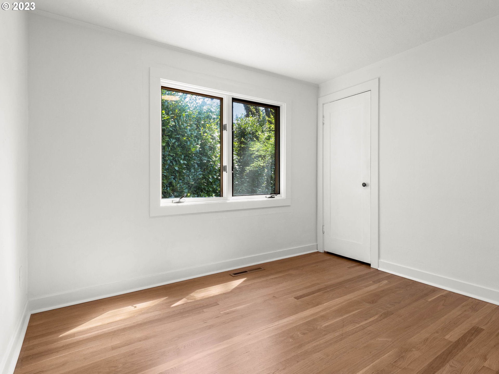3590 Southwest Patton Road Portland, OR 97221 - Photo 19 of 32 an empty room with wooden floor and windows