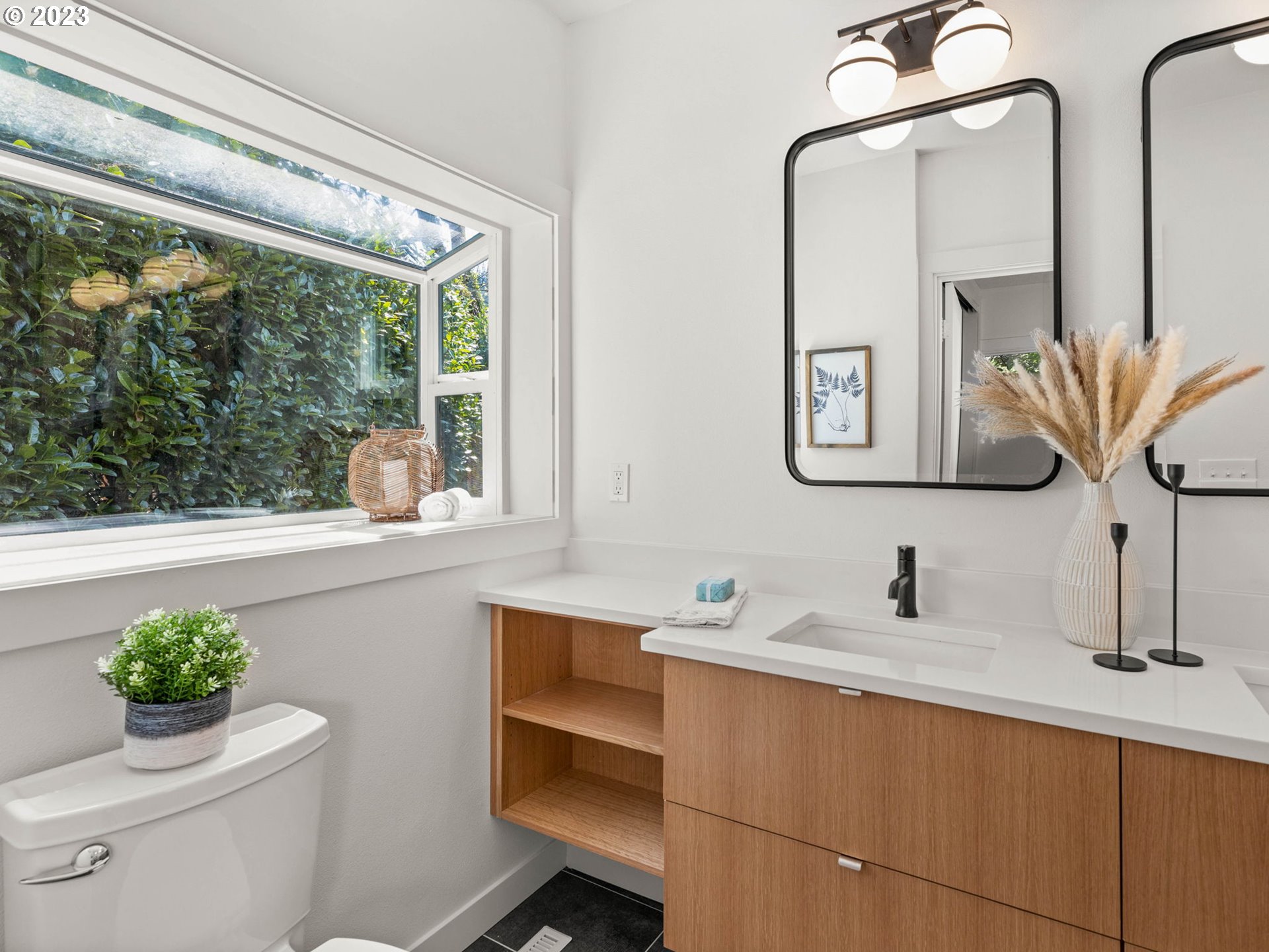 3590 Southwest Patton Road Portland, OR 97221 - Photo 26 of 32 a bathroom with a toilet sink and mirror