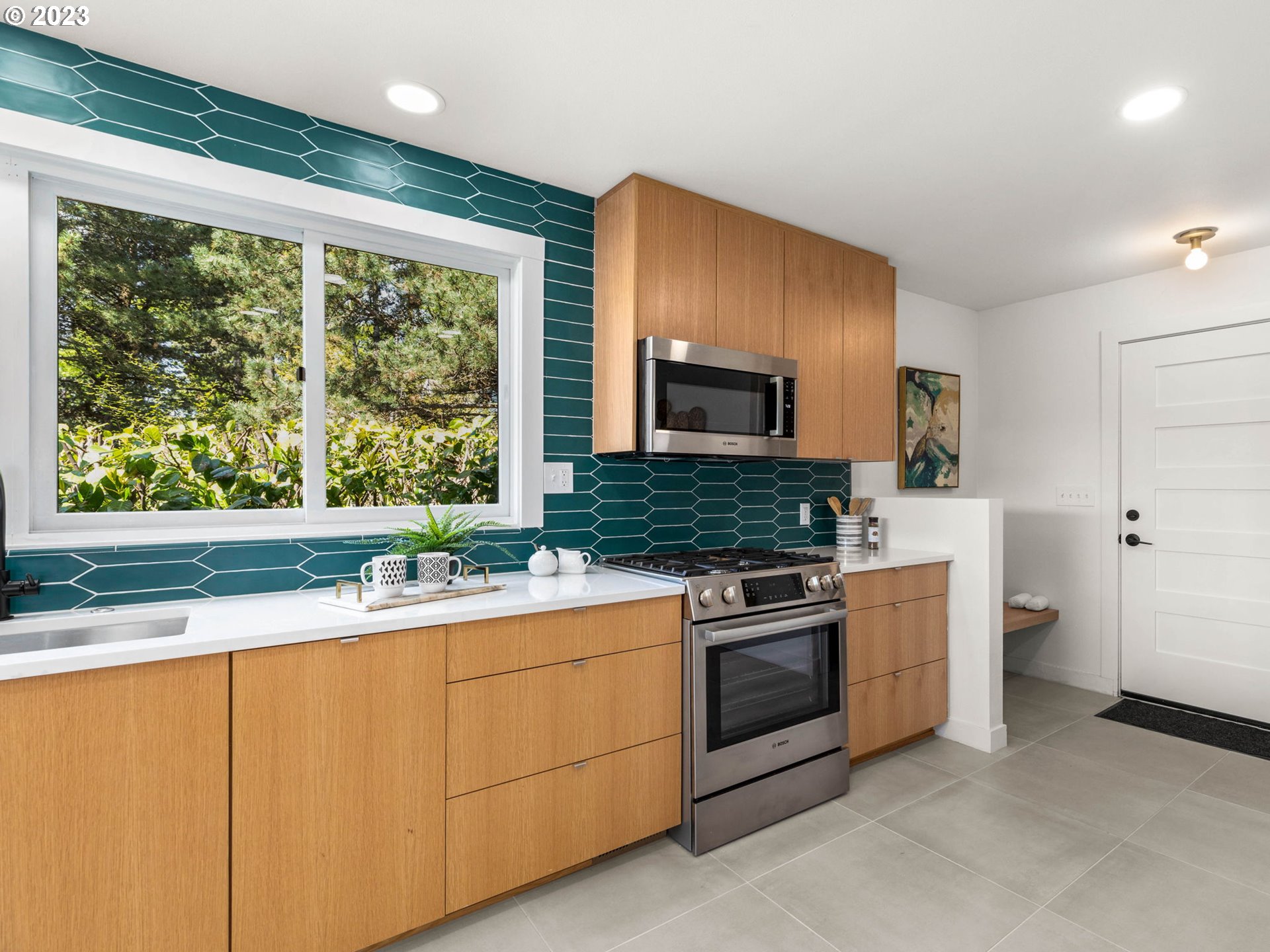 3590 Southwest Patton Road Portland, OR 97221 - Photo 7 of 32 a kitchen with a stove a sink and a microwave