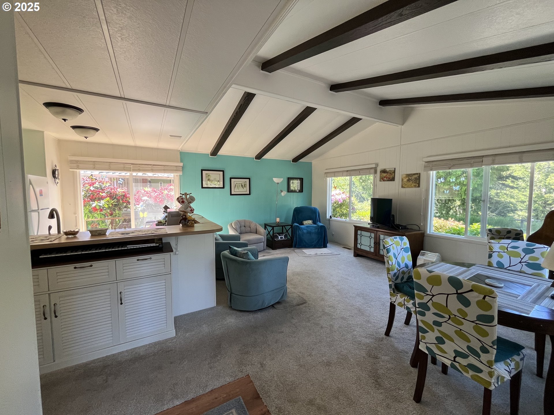 83763 Highway 101, Unit 10 Florence, OR 97439 - Photo 11 of 34 a living room with furniture a window and kitchen view