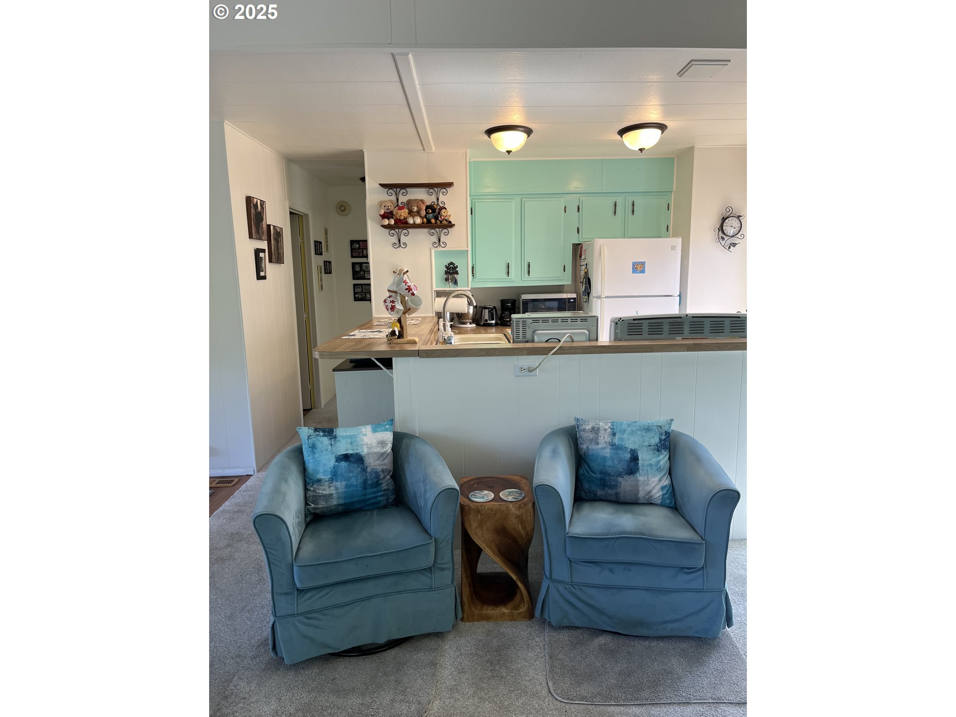 83763 Highway 101, Unit 10 Florence, OR 97439 - Photo 18 of 34 a living room with furniture and a wooden floor