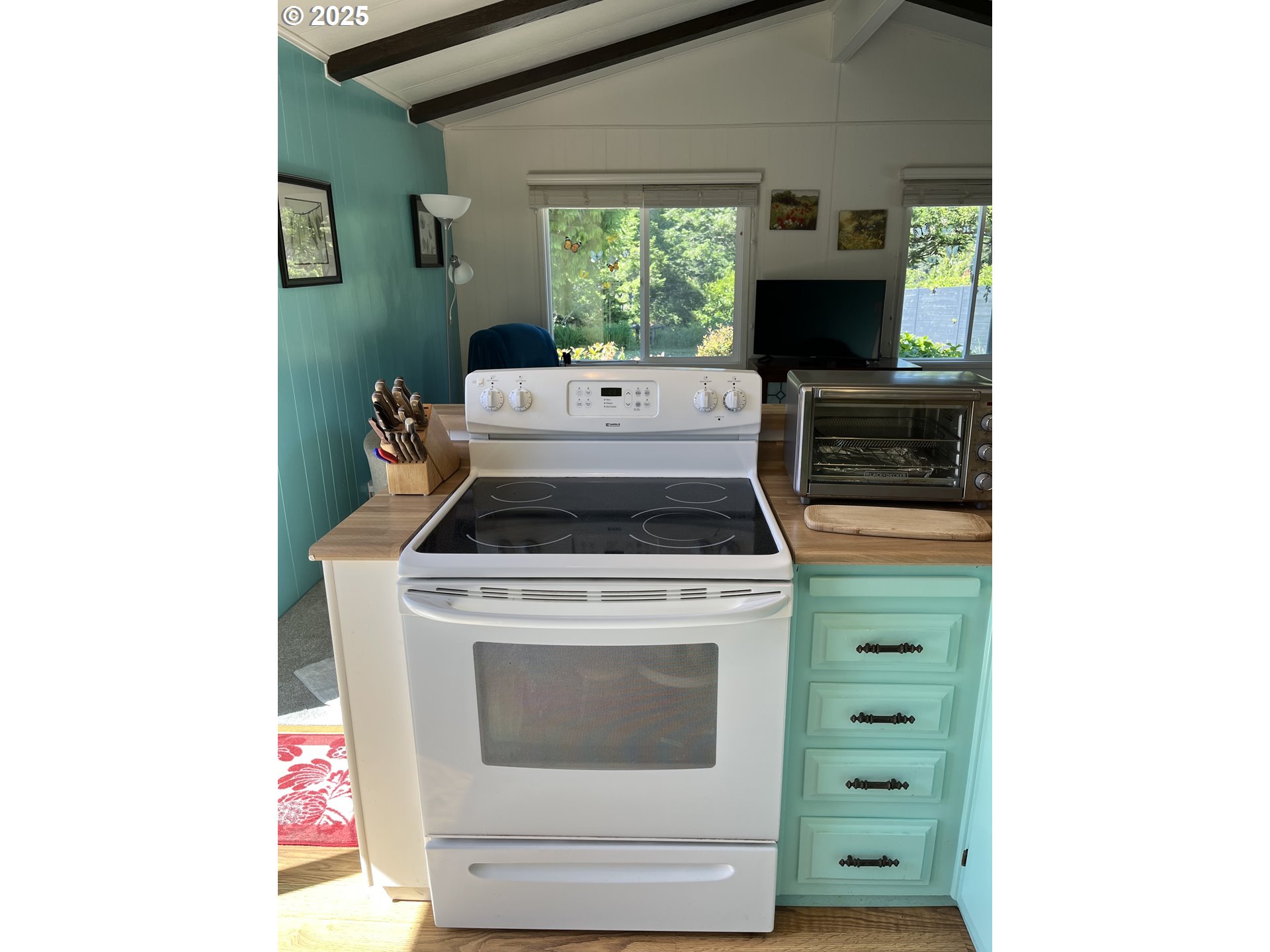 83763 Highway 101, Unit 10 Florence, OR 97439 - Photo 24 of 34 a kitchen with a stove and a microwave
