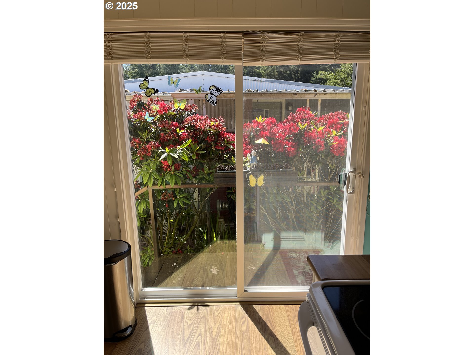 83763 Highway 101, Unit 10 Florence, OR 97439 - Photo 26 of 34 a view of a living room with a floor to ceiling window and tree