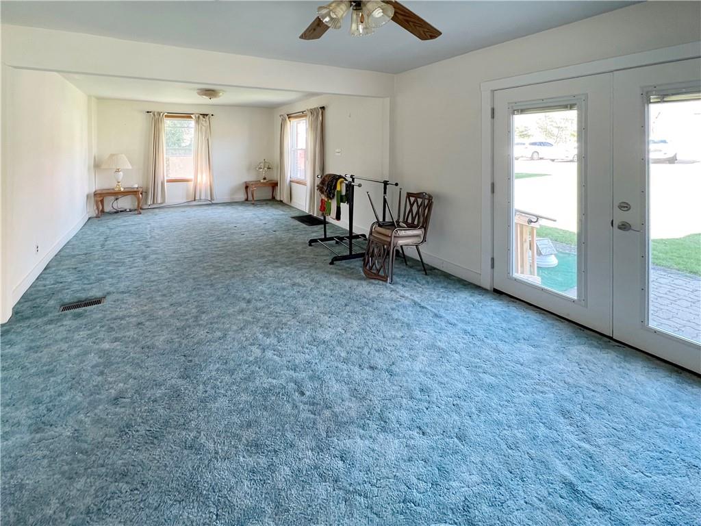 73 Noblestown Road Carnegie, PA 15106 - Photo 4 of 25 an empty room with windows and ceiling fan
