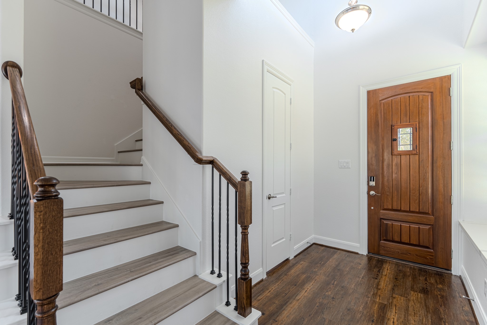 58 Aventura Place Spring, TX 77389 - Photo 13 of 50 a view of a hallway with wooden floor and entryway