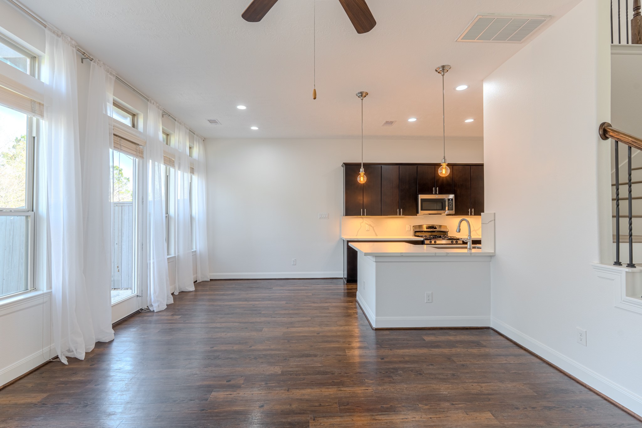 58 Aventura Place Spring, TX 77389 - Photo 16 of 50 Spacious family room with high ceilings and backyard views, perfect for gatherings and everyday comfort.