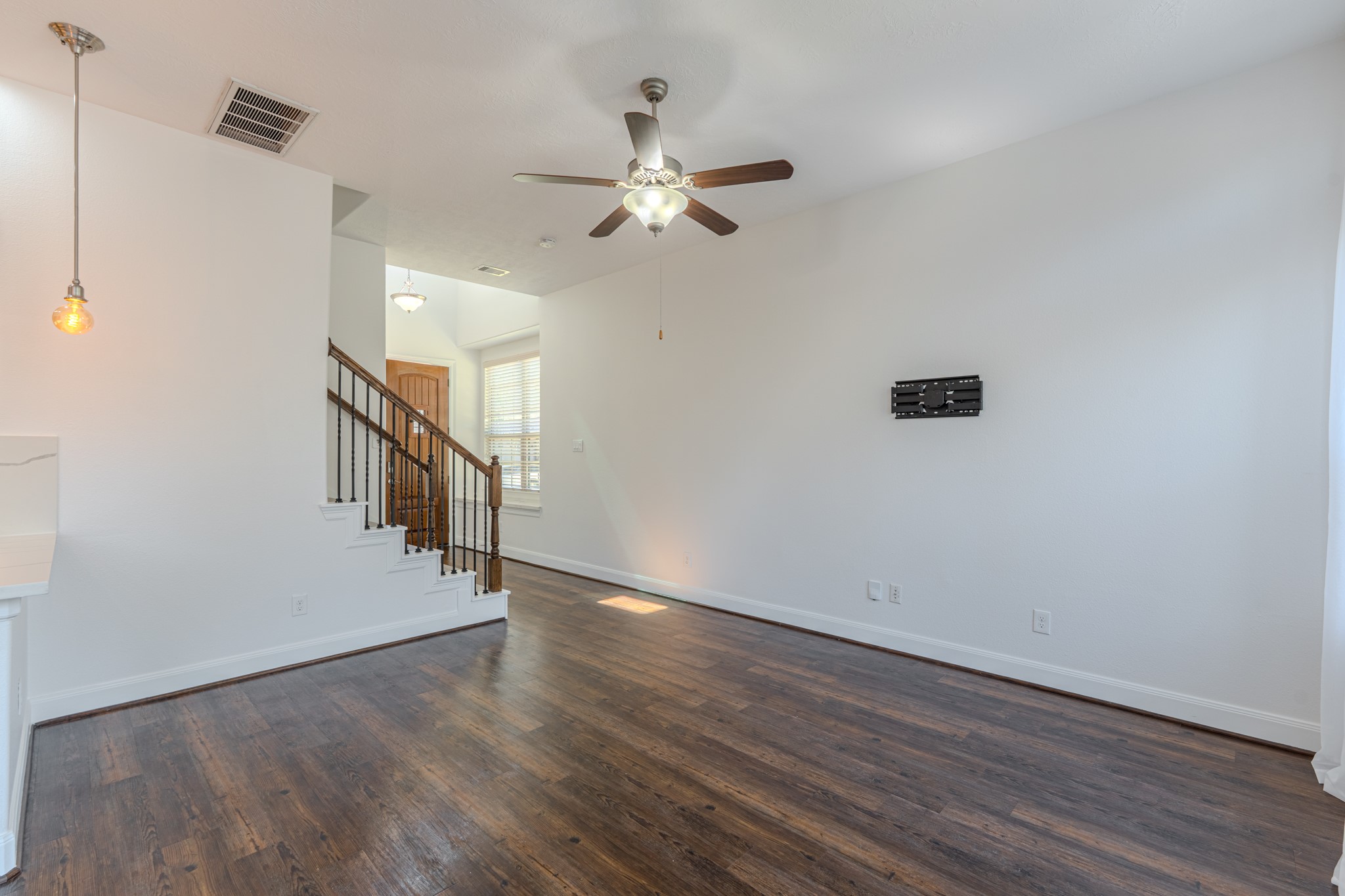 58 Aventura Place Spring, TX 77389 - Photo 18 of 50 Light-filled living area with clean architectural lines and open sightlines to the kitchen, creating a warm yet sophisticated atmosphere.