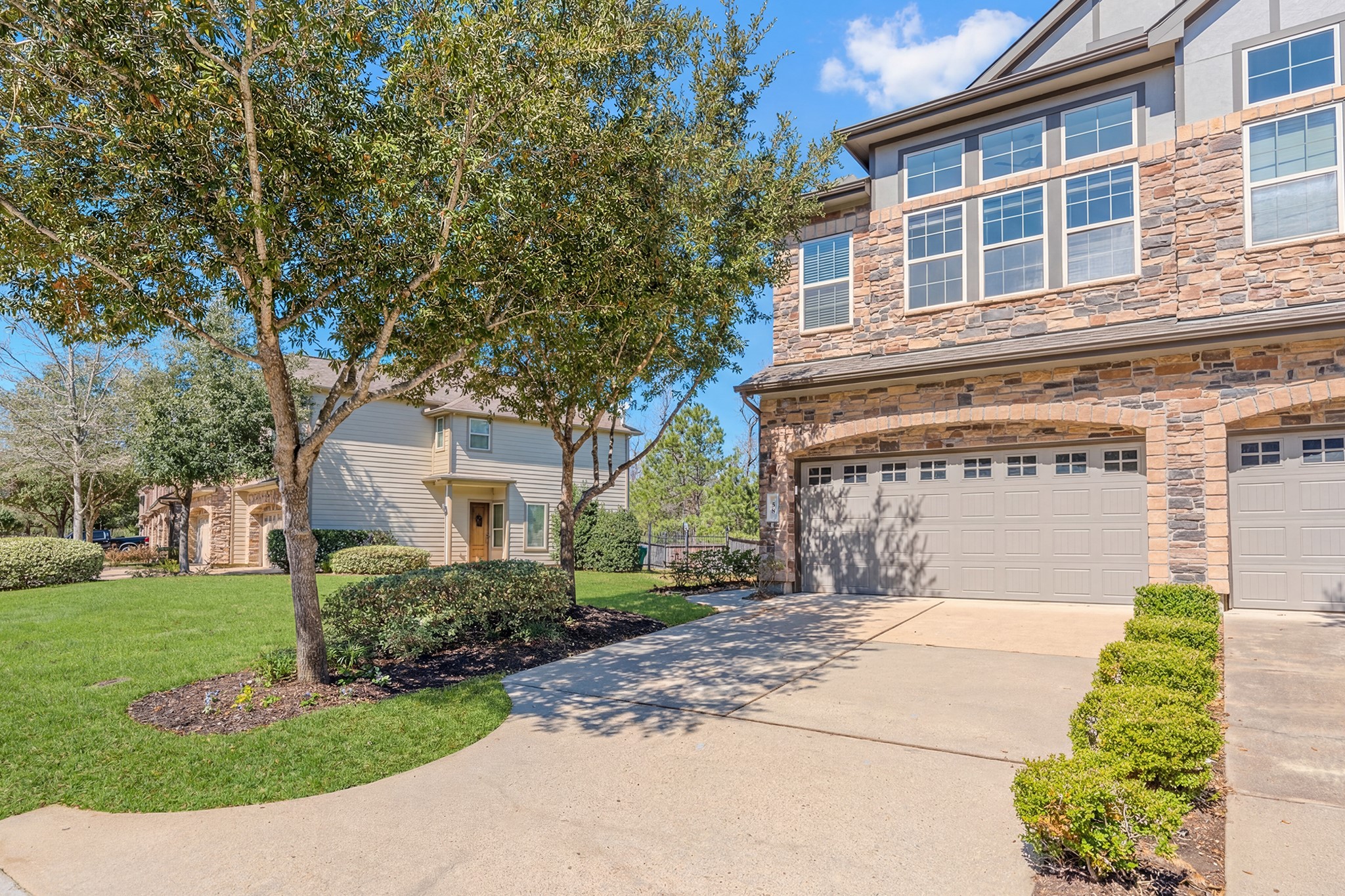 58 Aventura Place Spring, TX 77389 - Photo 2 of 50 a front view of a house with a garden and plants