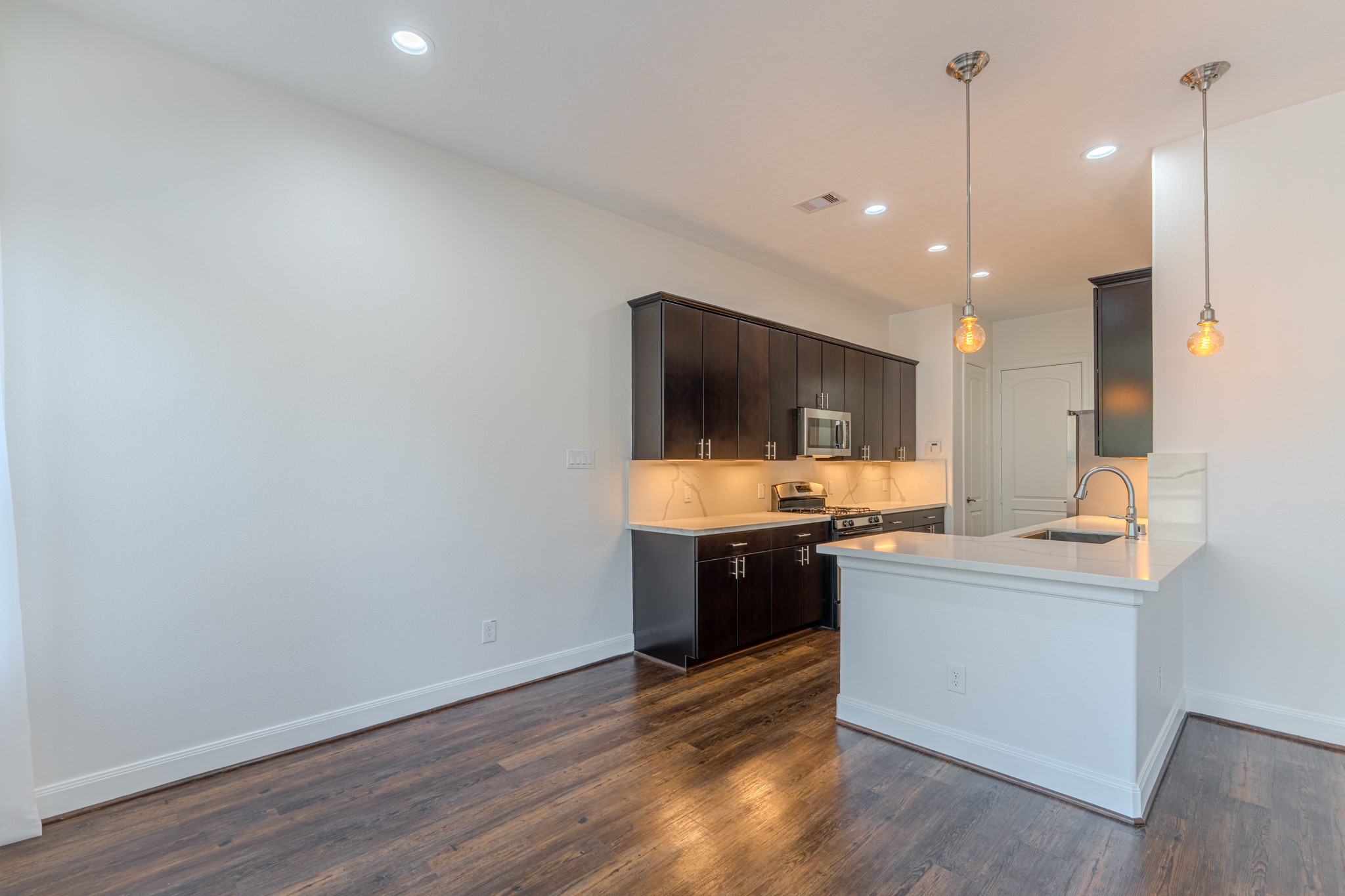 58 Aventura Place Spring, TX 77389 - Photo 22 of 50 a kitchen with a sink and a stove top oven