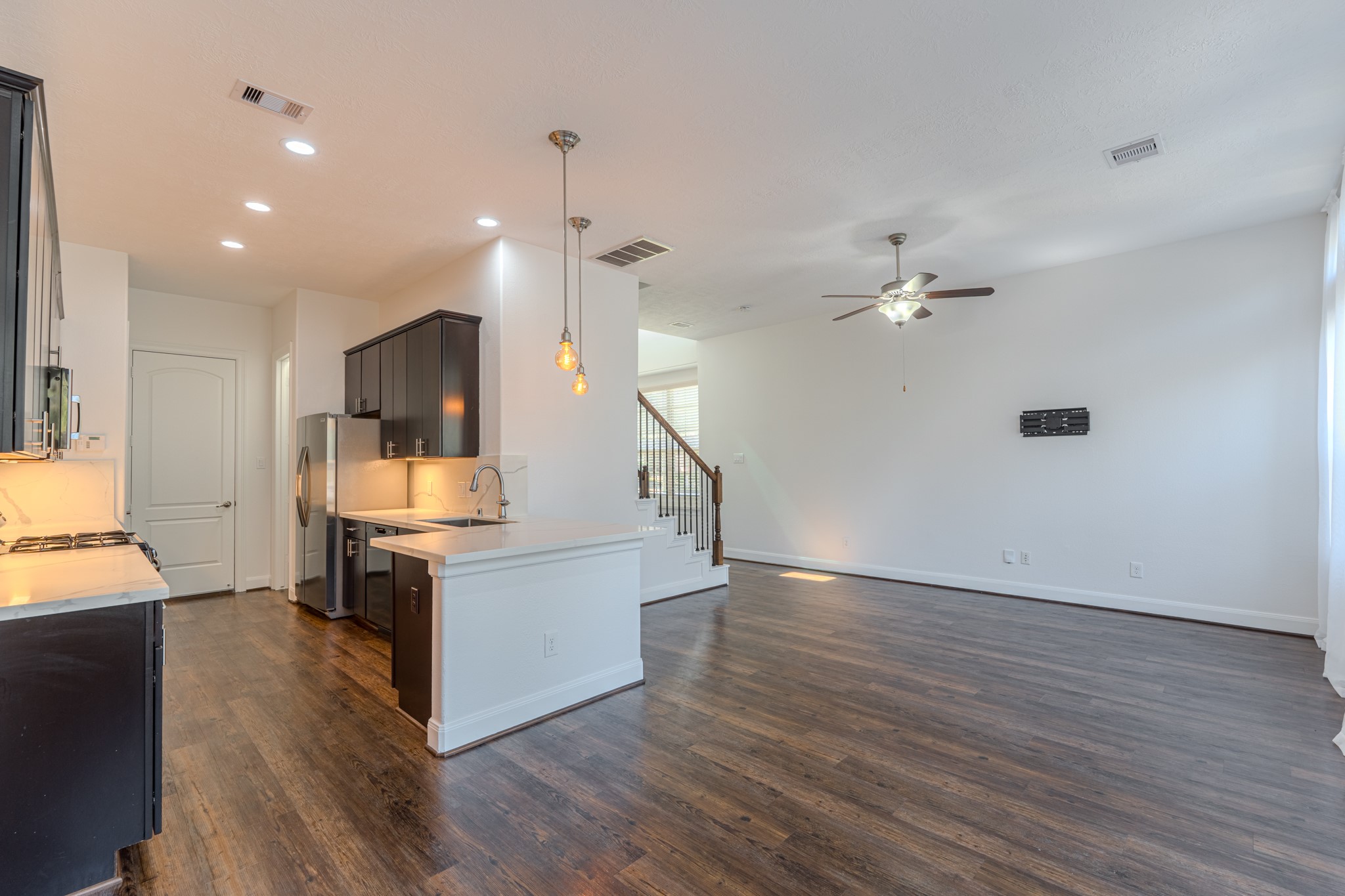 58 Aventura Place Spring, TX 77389 - Photo 23 of 50 Gourmet kitchen with quartz countertops, oversized island, and abundant cabinetry for storage.