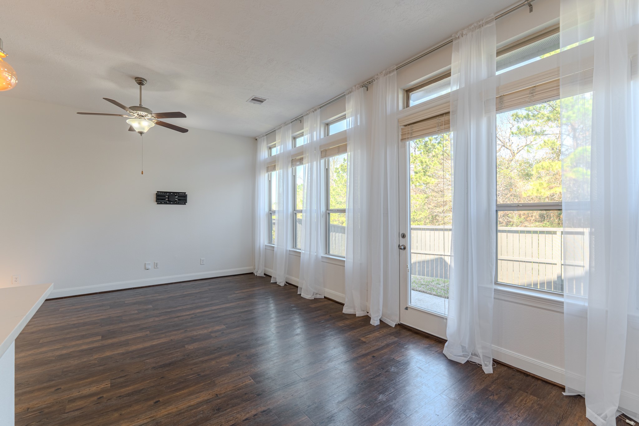 58 Aventura Place Spring, TX 77389 - Photo 24 of 50 a view of an empty room with a window and wooden floor