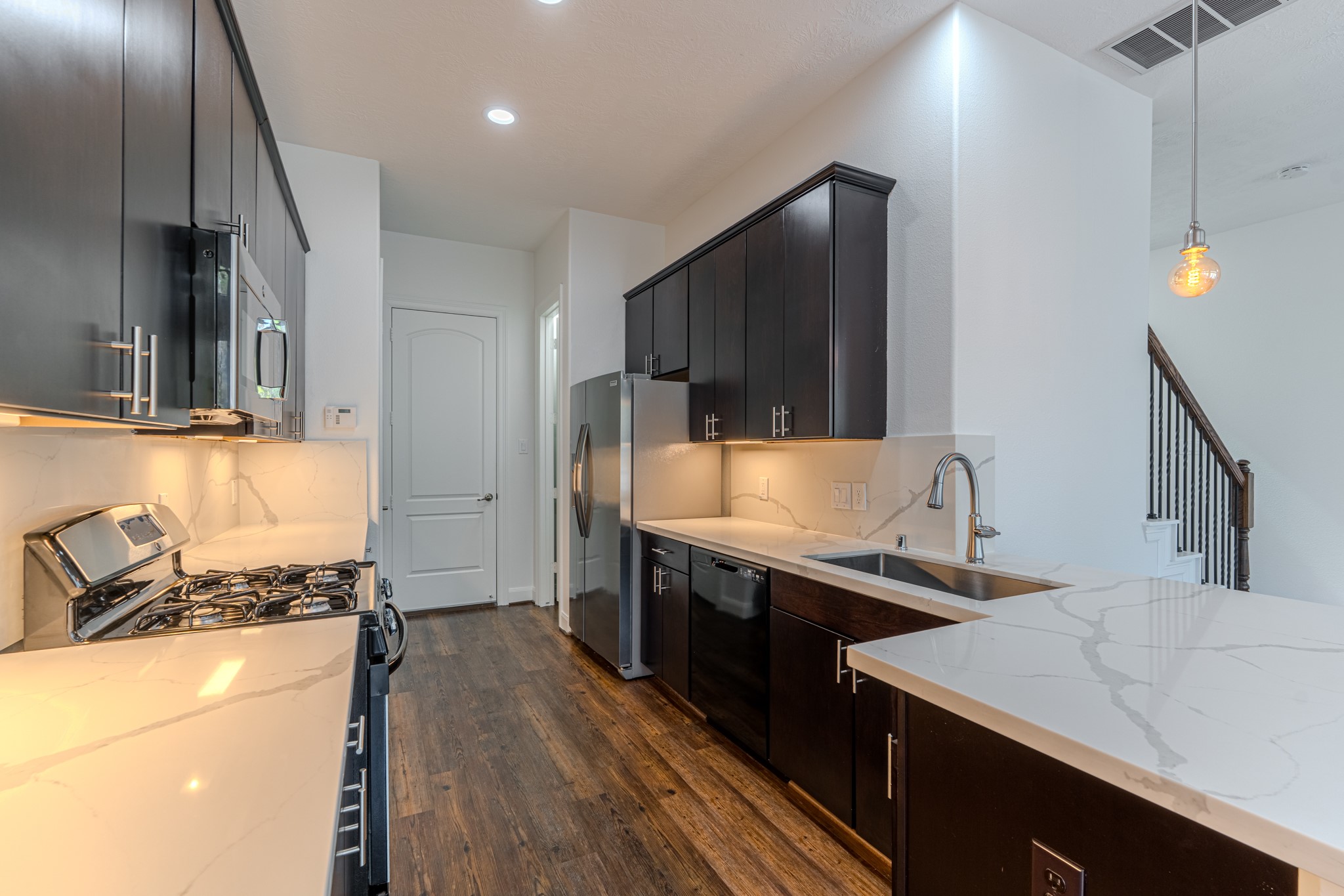 58 Aventura Place Spring, TX 77389 - Photo 27 of 50 a kitchen with stainless steel appliances a sink stove and refrigerator