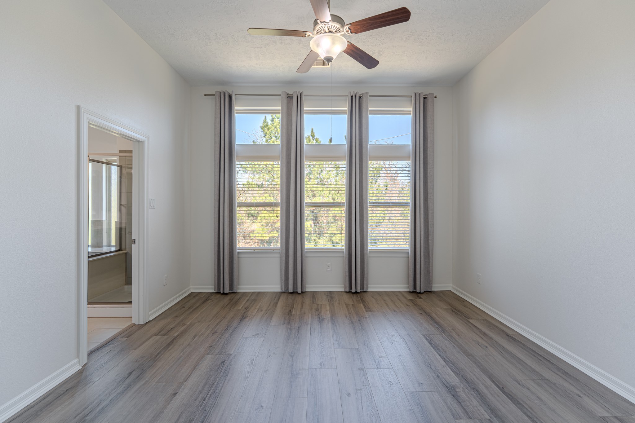 58 Aventura Place Spring, TX 77389 - Photo 31 of 50 an empty room with wooden floor and windows