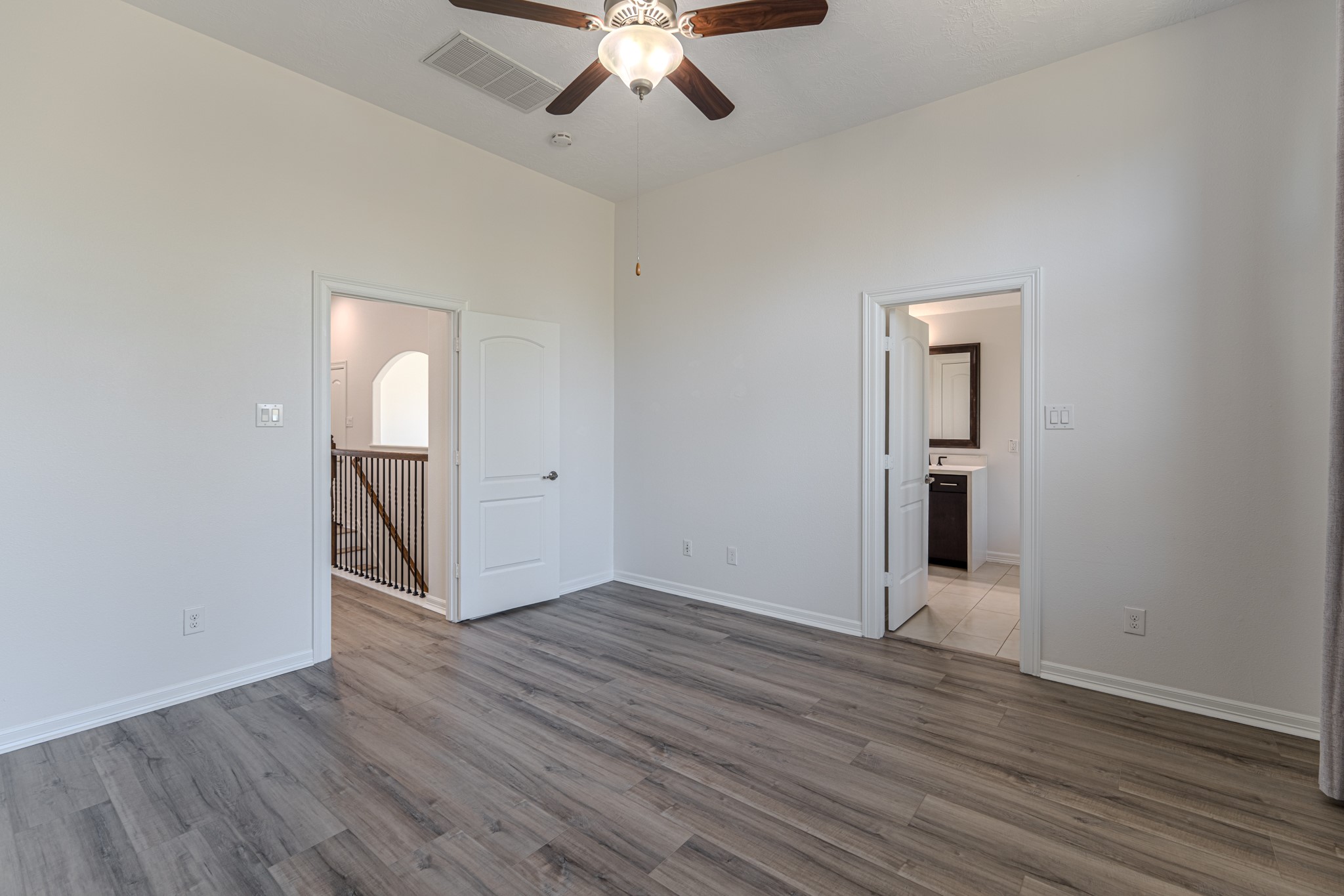 58 Aventura Place Spring, TX 77389 - Photo 33 of 50 Spacious owner’s suite with elegant design and ample room for king-sized furnishings and additional seating.