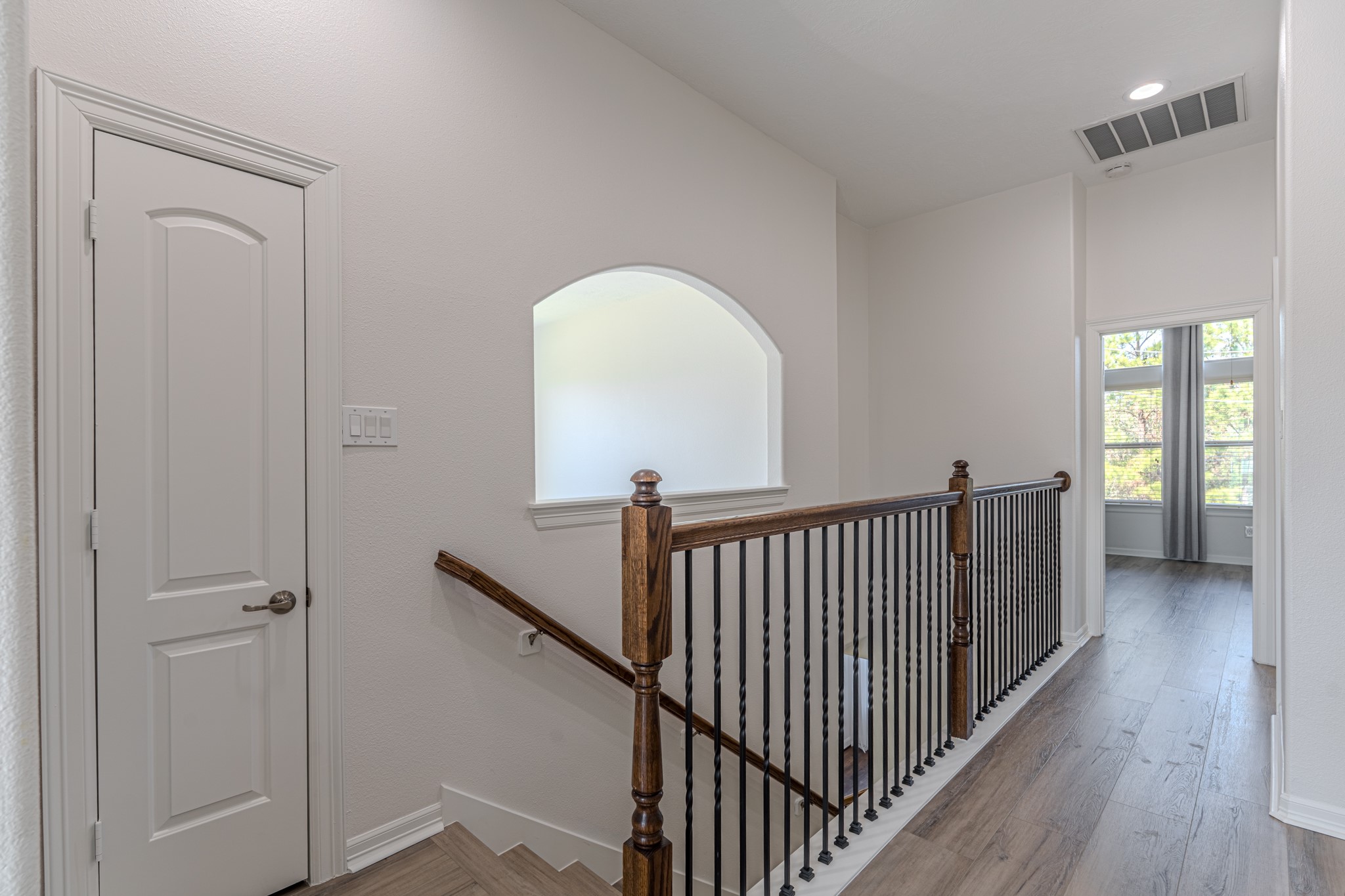 58 Aventura Place Spring, TX 77389 - Photo 50 of 50 a view of a hallway with wooden floor and stairs