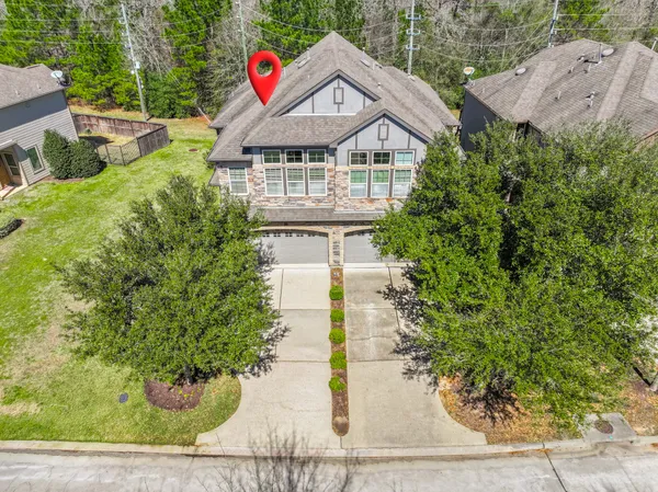 an aerial view of residential house with outdoor space and swimming pool