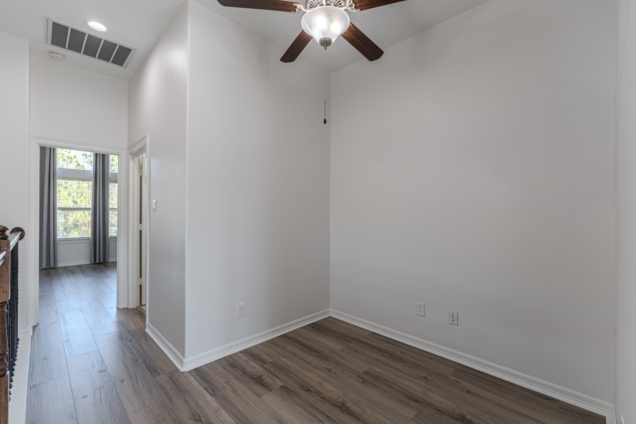 58 Aventura Place Spring, TX 77389 - Photo 40 of 50 a view of an empty room with window and wooden floor