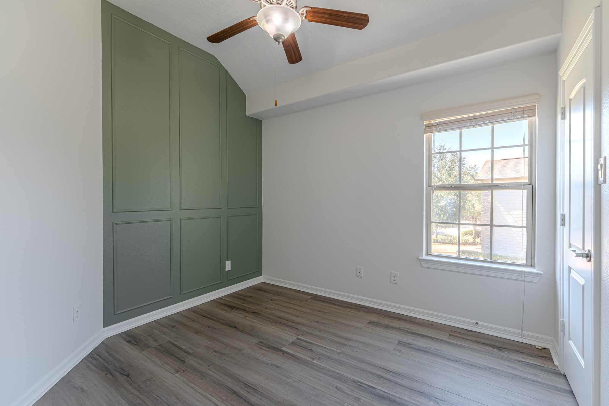58 Aventura Place Spring, TX 77389 - Photo 42 of 50 an empty room with wooden floor cabinet and windows